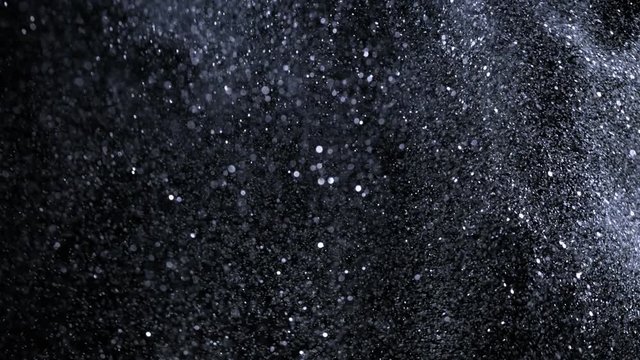 Super slow motion of glittering silver particles on black background. Shallow depth of focus. Filmed on high speed cinema camera, 1000 fps.