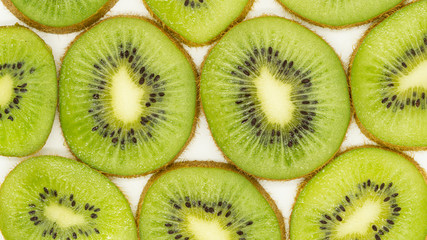 Fototapeta premium Abstract photo of a green slices kiwi fruit background. Food concept. flat lay, top view. Close up. Banner. 