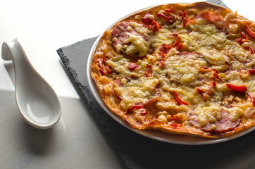 Plate with pizza on a white table