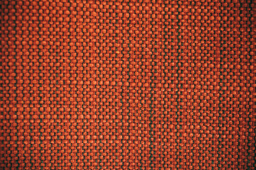 Macro view of orange fabric as texture and background for design.	