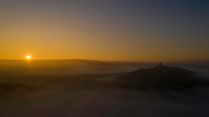 beautiful sunrise over the fog with a view of the castle ruins in the Bavarian forest 