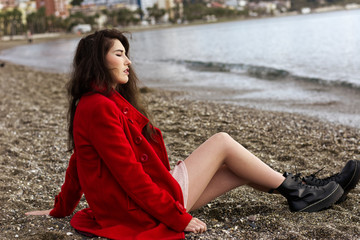 Woman lying on the sand of the beach enjoying the sun and tranquility on a winter day