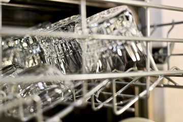 Fragment of the top lattice dishwasher with clean transparent glass utensils, is a little on the...