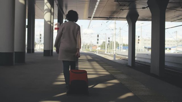 Senior elegant woman is waiting for the arrival of a train