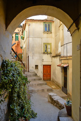Fototapeta premium Castelcivita, Italy. A narrow street between the old houses of a medieval village