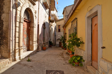 Fototapeta na wymiar Castelcivita, Italy. A narrow street between the old houses of a medieval village