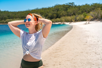 Happy Sunbathing Woman At the Lake Mckenzie beach on Fraser Island Great Sandy National Park,...