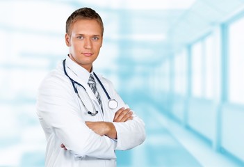 Young doctor portrait at blurred hospital background