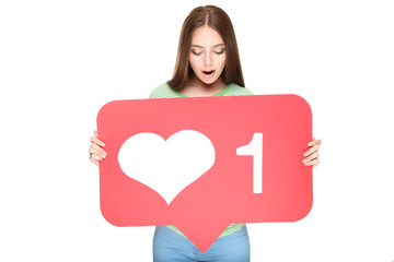 Young woman holding paper card with heart and number one on white background