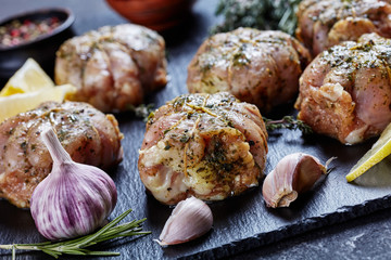 raw rabbit ballotines on a slate tray