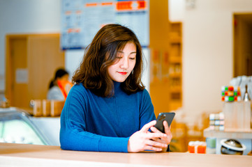 pretty young lady smile and enjoy with iPhone11pro in afternoon 