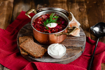 Freshly cooked homemade russian famous soup borsch. Served in cooper pan with garlic, sour cream...