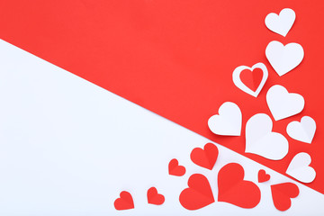 Paper hearts on white and red background