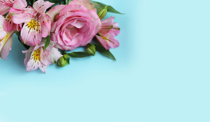 Delicate floral arrangement. Pink flowers on light blue background - roses and astromeria. Background for greetings, invitations, and postcards. © Olirina