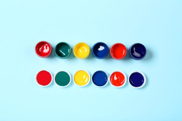 Colorful gouache paints on blue background