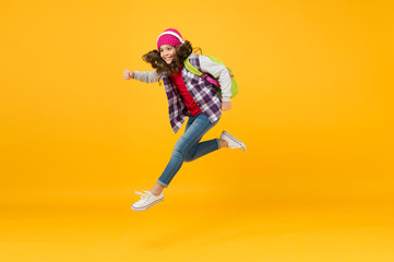 sense of freedom. childhood activity. little girl listen music in headset with backpack. back to school. small schoolgirl running to school. hurry up its holiday time. child being late. energy jump