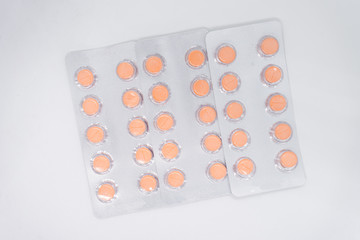 orange pills in blister pack, medications drugs. Pharmaceutical industry concept. 