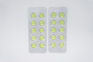 green pills in blister pack, medications drugs. Pharmaceutical industry concept. 