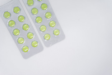 green pills in blister pack, medications drugs. Pharmaceutical industry concept. 