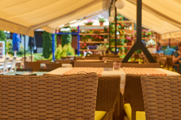 Detail from a outdoor cafe - part of chairs and tables - showing cozy atmosphere