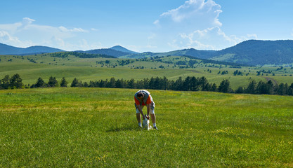Man and dog in a wonderful mountain landscape in spring