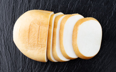 Cheese on a slate board. Smoked cheese close-up.