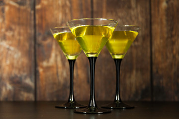 three yellow cocktails glasses