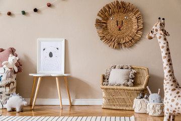 Stylish and modern scandinavian newborn baby interior with mock up photo frame on the small table....