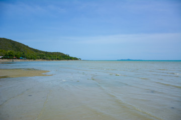 Beautiful rock beach with sea ocean and mountain blue sky landscape background,An island in the sea with beaches, rocks and turquoise water in the hot summer sun of Thailand.