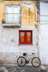 Obraz na płótnie Canvas Procida (Italy) - Colored walls and bike in Procida, a little island in Campania, southern Italy