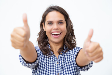 Cheerful young woman showing thumbs up. Beautiful happy young woman showing thumbs up and smiling...