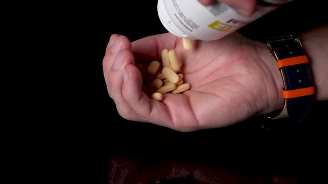 B12 Vitamin Pills Being Poured into Hand