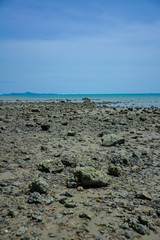Stone courtyard on the public beach,Beautiful seascape with natural stone yard on beach against cloudy sky,Rocky shore at the seacoast with seascape and blue sky,