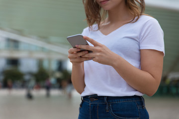 Closeup shot of female hands using smartphone. Cropped shot of young woman holding modern phone. Technology concept