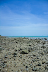 Stone courtyard on the public beach,Beautiful seascape with natural stone yard on beach against cloudy sky,Rocky shore at the seacoast with seascape and blue sky,