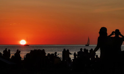 Fototapeta na wymiar silhouette of people on the beach at sunset