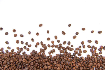 fresh roasted coffee beans sprinkled on a white background