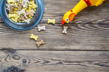 Dog food selection on wooden background with copy space, top view