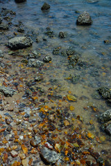 Stone courtyard on the public beach,Beautiful seascape with natural stone yard on beach against cloudy sky,Rocky shore at the seacoast with seascape and blue sky,