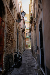 Fototapeta na wymiar one of the charming, narrow street in Ortigia, oldest part of the beautiful baroque city of Syracuse in Sicily, Italy