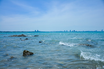 Stone courtyard on the public beach,Beautiful seascape with natural stone yard on beach against cloudy sky,Rocky shore at the seacoast with seascape and blue sky,