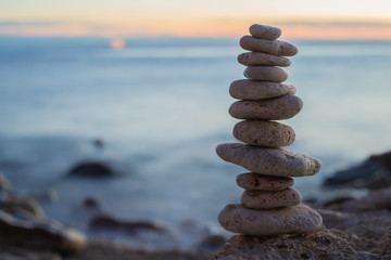 Fototapeta na wymiar Zen concept. Sunset. The object of the stones on the beach at sunset. Relax & Meditation. Zen stones. Blue hour