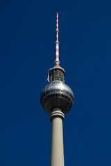 Berlin Fernsehturm (TV-tower) isolated against a deep blue sky with no clouds visible