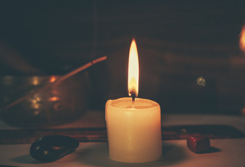 Candle flame, gemstones, incense stick and tibetan bowl 