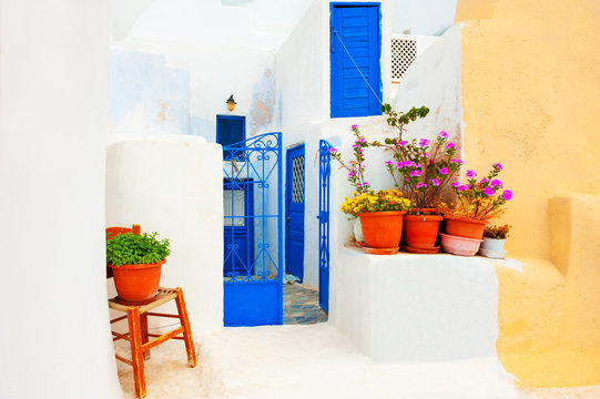Traditional greek architecture and decor with flowers on Santorini island, Greece. © smallredgirl