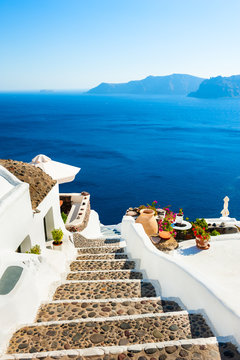 White architecture and blue sea on Santorini island, Greece. Stairs to the sea. Summer holidays, travel destinations concept