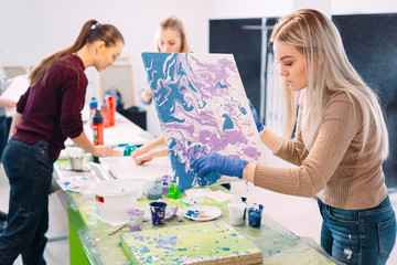 Fototapeta premium People of all ages are fond of drawing. Acrylic paint flows over the canvas. chaotic drawing.