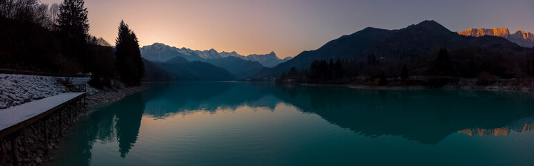 The panorama of the twilight sunset over the lake Barcis, Italy