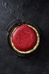 Homemade Nordic lingonberry pie in vintage metal tray on black background top view