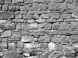 Masonry stone wall texture, background in black and white.
